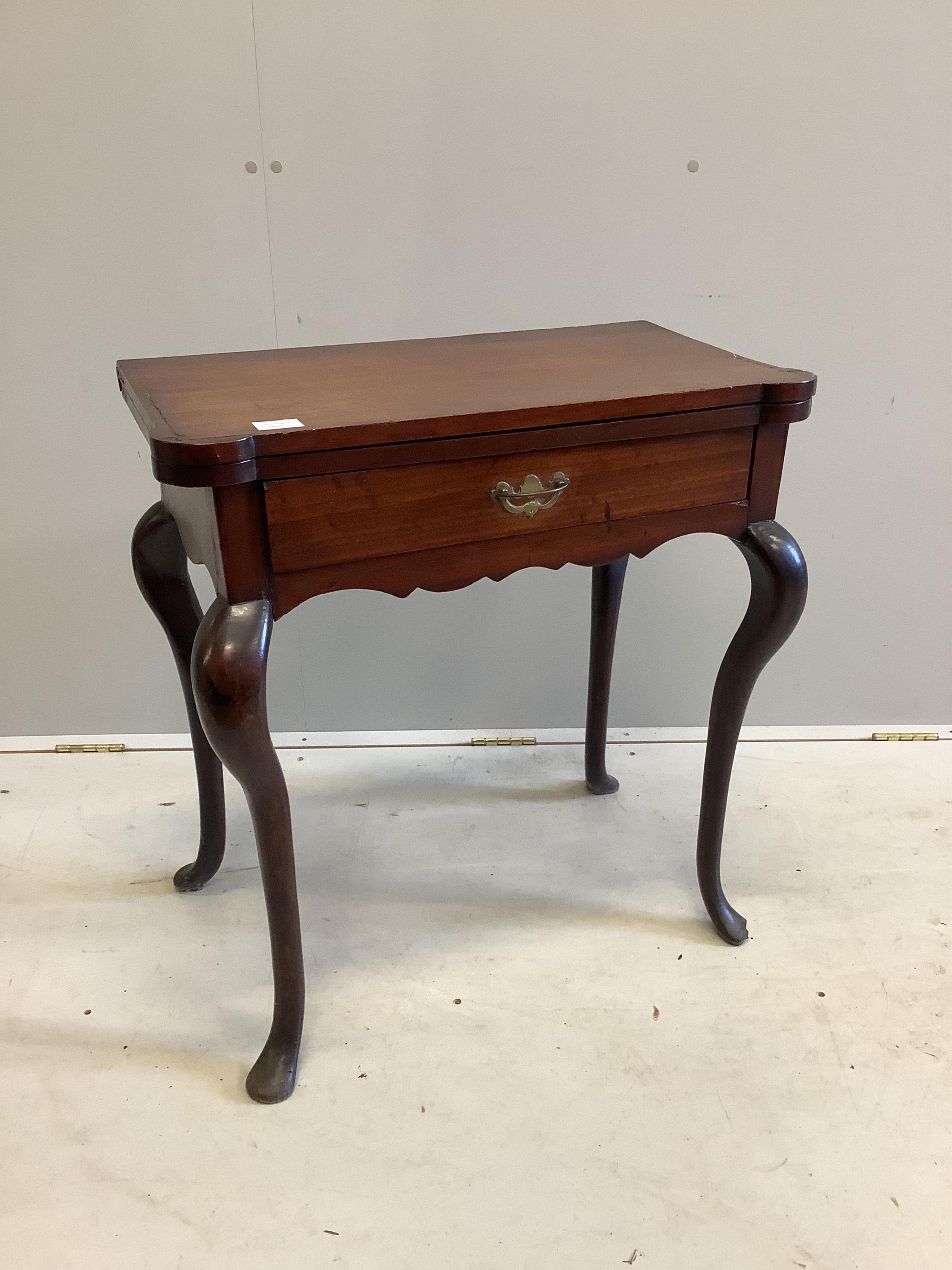 A George III mahogany folding tea table, on cabriole legs, width 67cm, depth 37cm, height 72cm. Condition - poor to fair